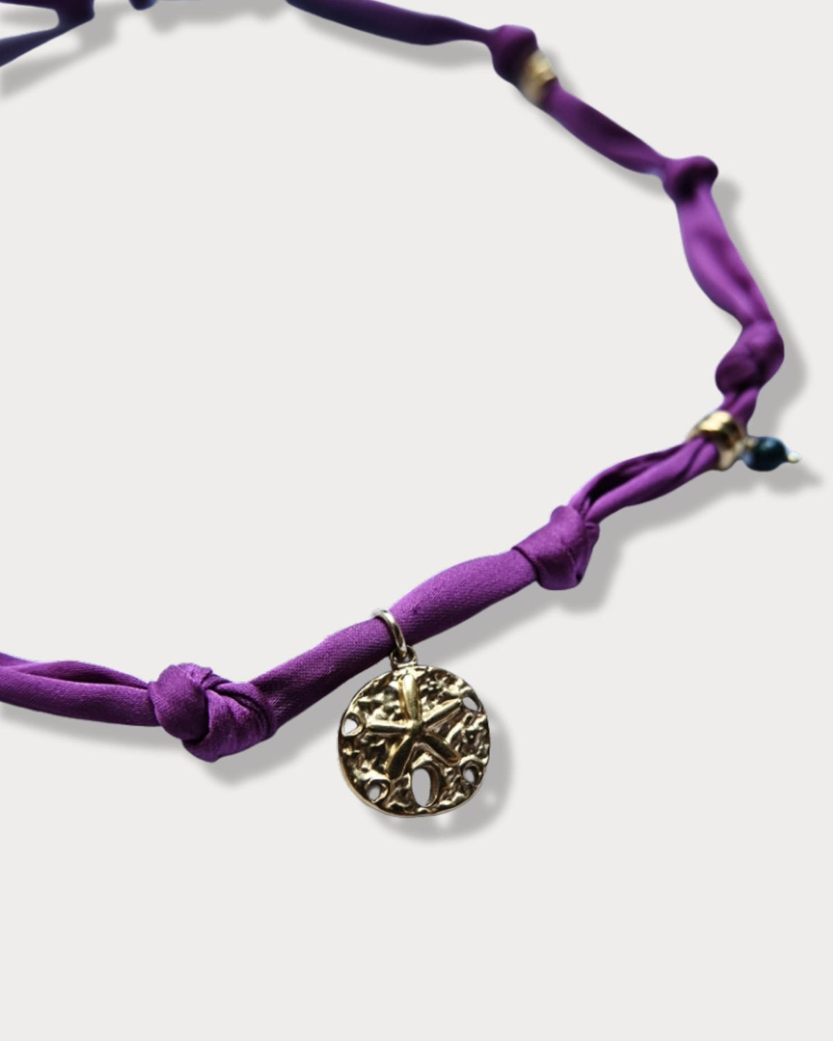 Collana in tessuto annodato color prugna con stella marina e pietre di agata indiana