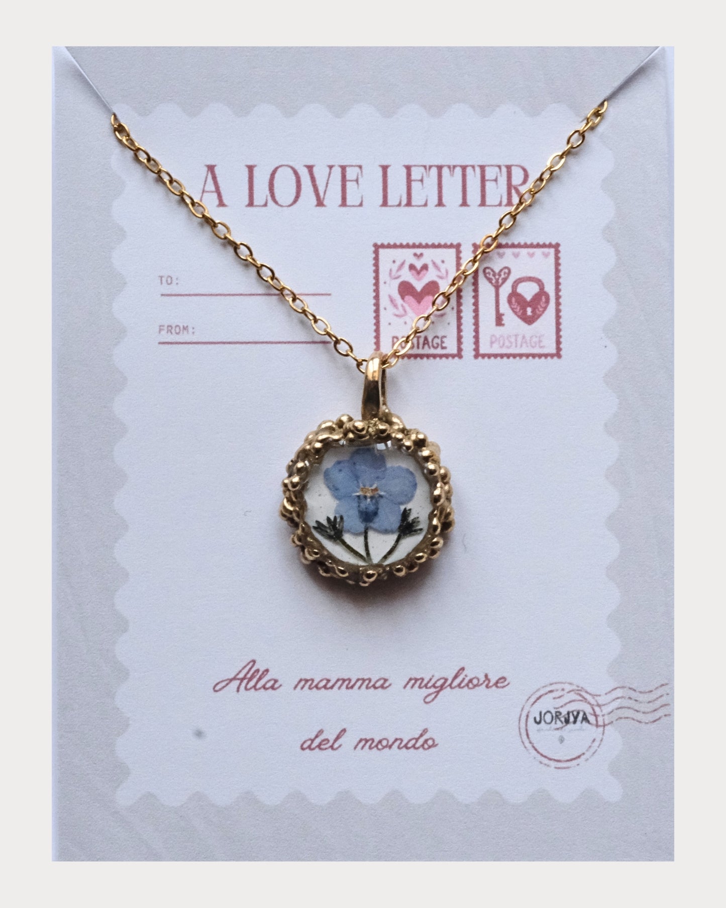 Collana con fiore di non ti scordar di me su base bianca