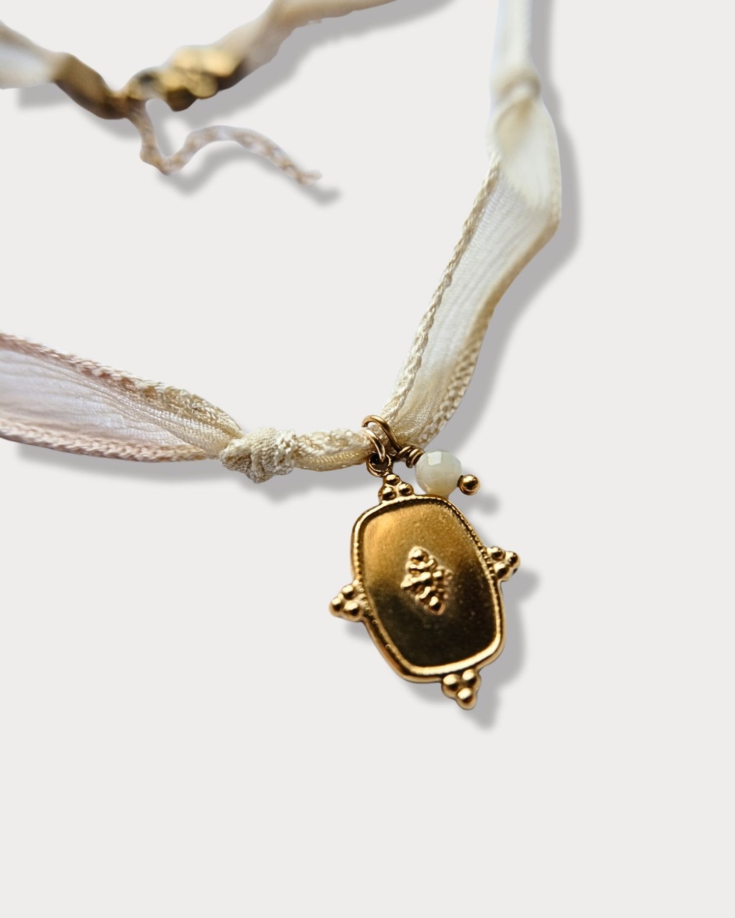 Collana in seta annodata rosa e vaniglia con pendente a forma di medaglietta e pietra di amazzonite